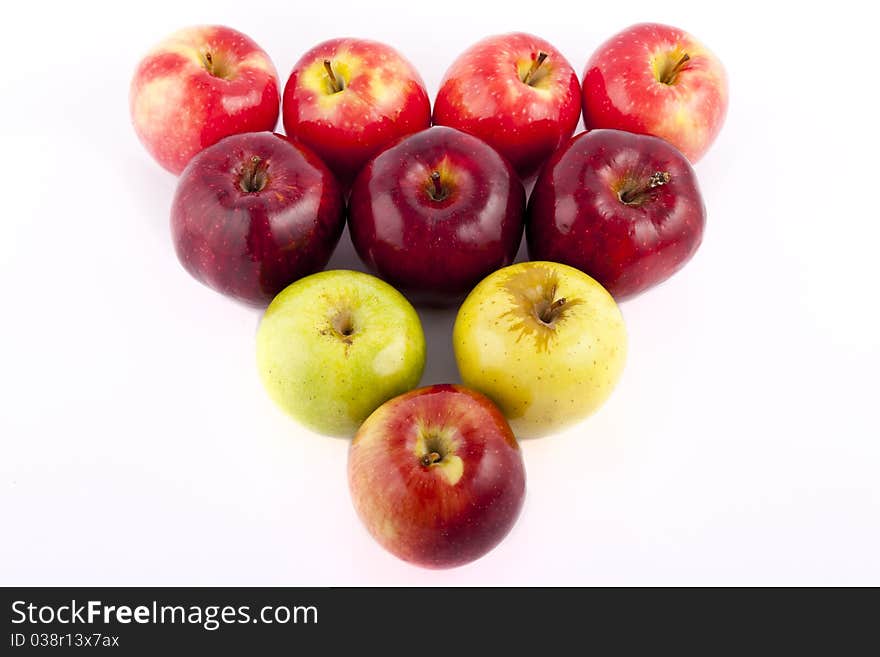 Yellow apple with brown spots on a white background