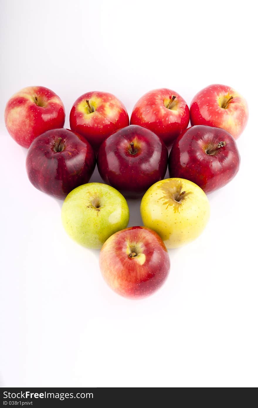 Yellow apple with brown spots on a white background