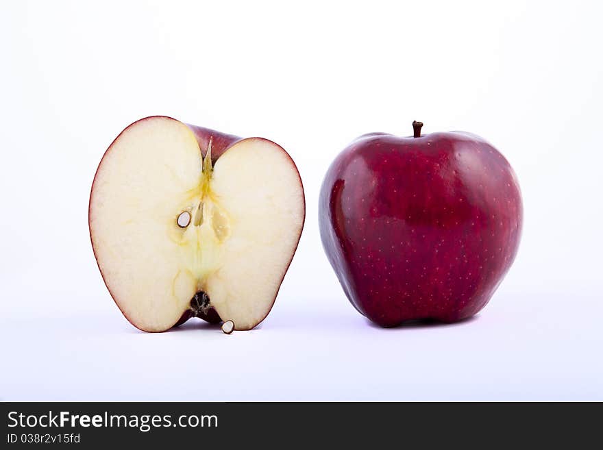 Yellow apple with brown spots on a white background