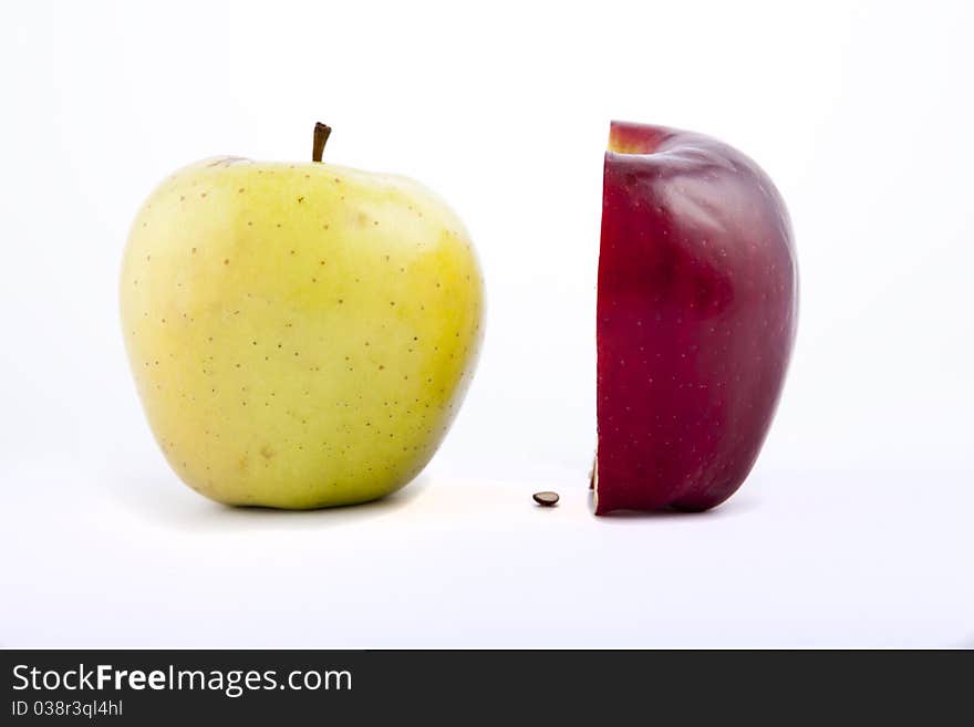 Yellow apple with brown spots on a white background