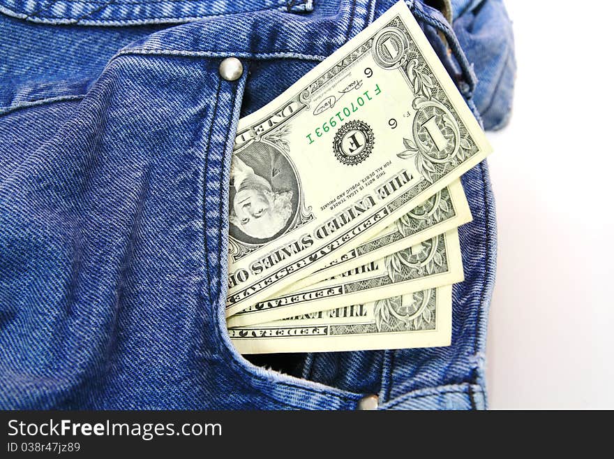 US dollar bills in blue jeans pocket.