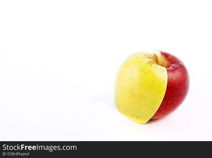 Yellow apple with brown spots on a white background