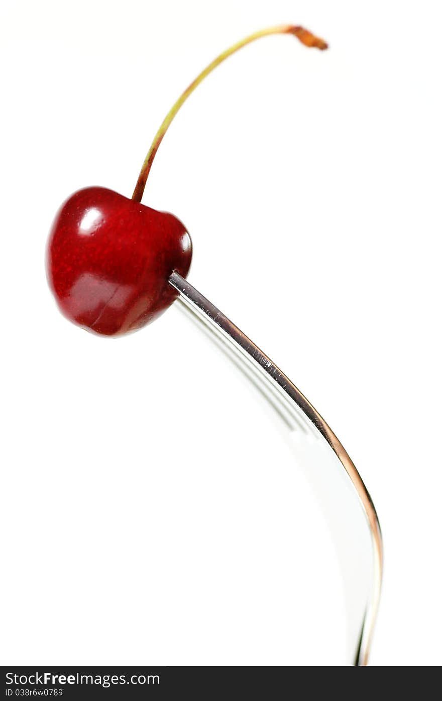 One fork with one red cherry. One fork with one red cherry