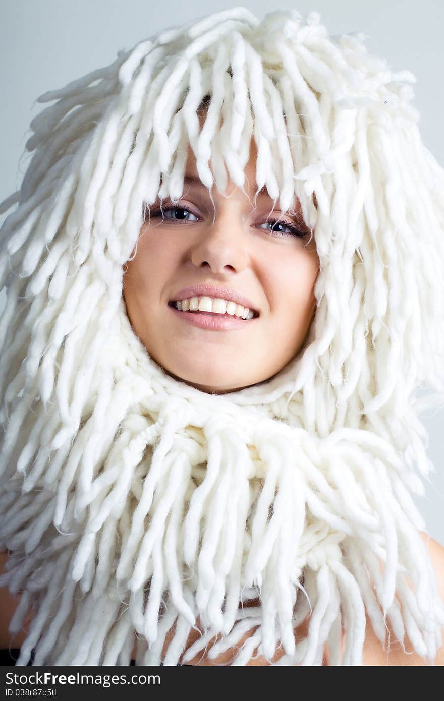 Smiling woman with funny white wig on the head