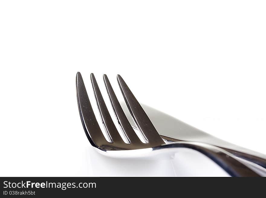 Knife and fork on a white background - tableware.