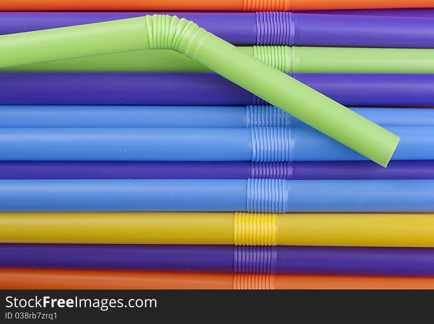 Plastic tubes of different colors in the background.