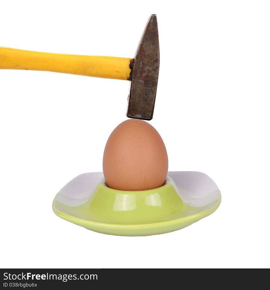 Hammer breaks an egg, isolated on white