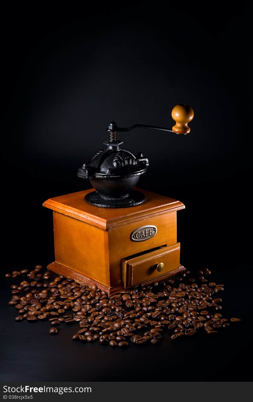 Coffe beans and grinder on a black background. Coffe beans and grinder on a black background