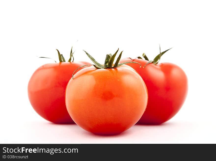 Red tomatoes on white background