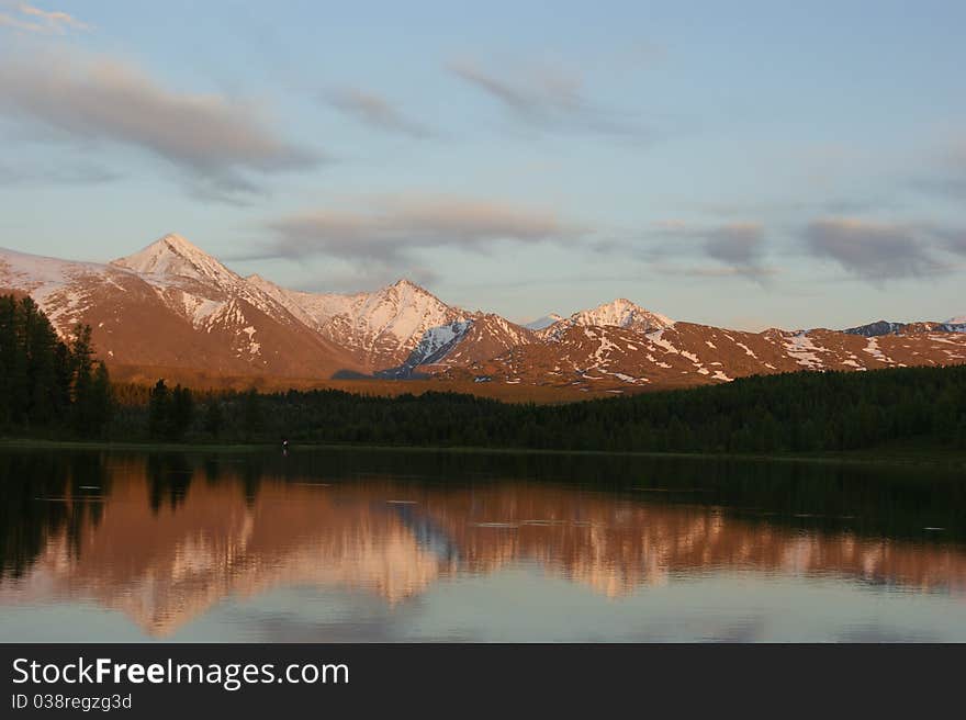 Sunset on the bank of mountain lake. Sunset on the bank of mountain lake