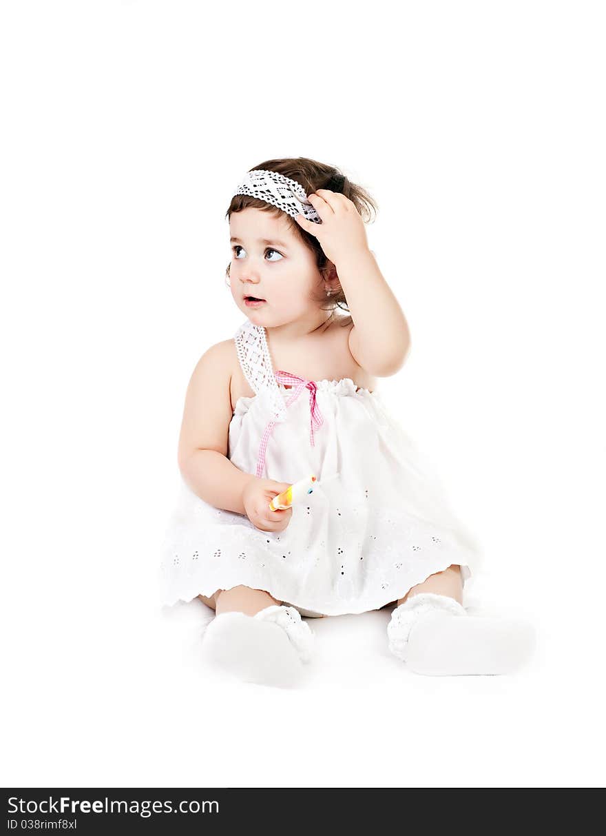 Baby girl in a white dress isolated on white