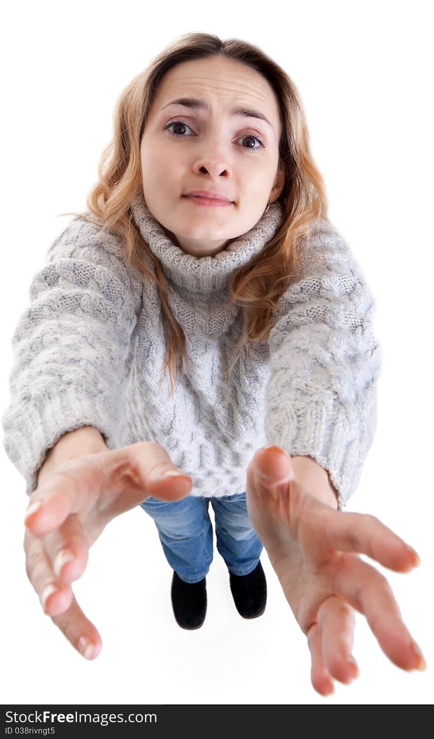 Plaintively beautiful blonde pulls her hands on a white background