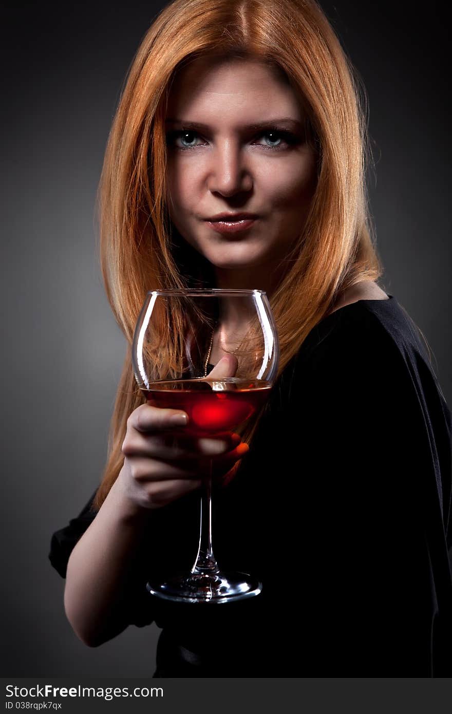 Woman with red hair holding wine glass. Woman with red hair holding wine glass