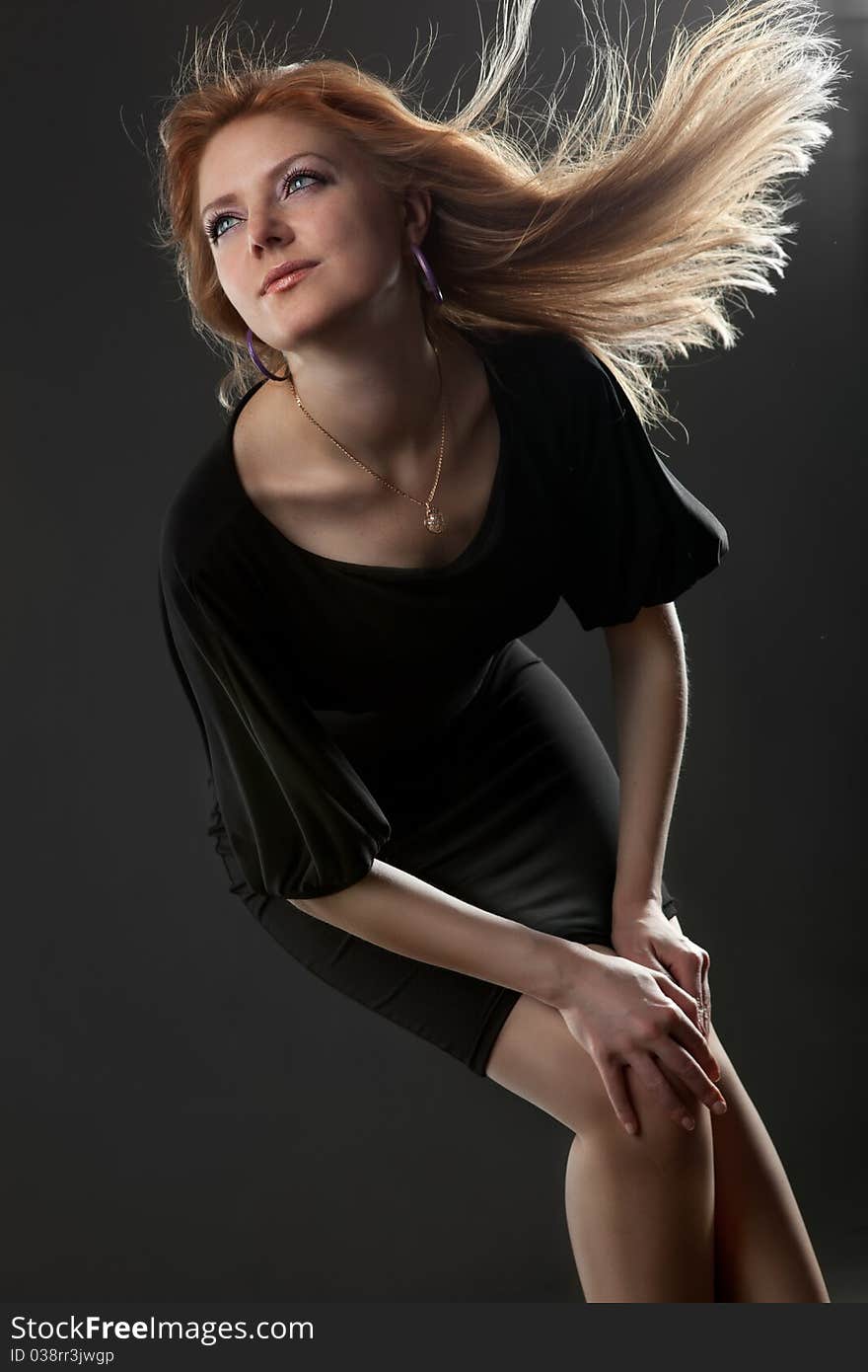 Portrait of attractive young smiling woman on black