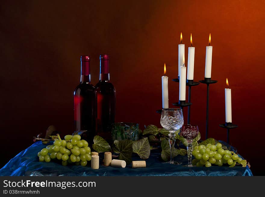 Arrangement of  wine bottle, glass, grapes, vine plant, corks  in studio. Arrangement of  wine bottle, glass, grapes, vine plant, corks  in studio