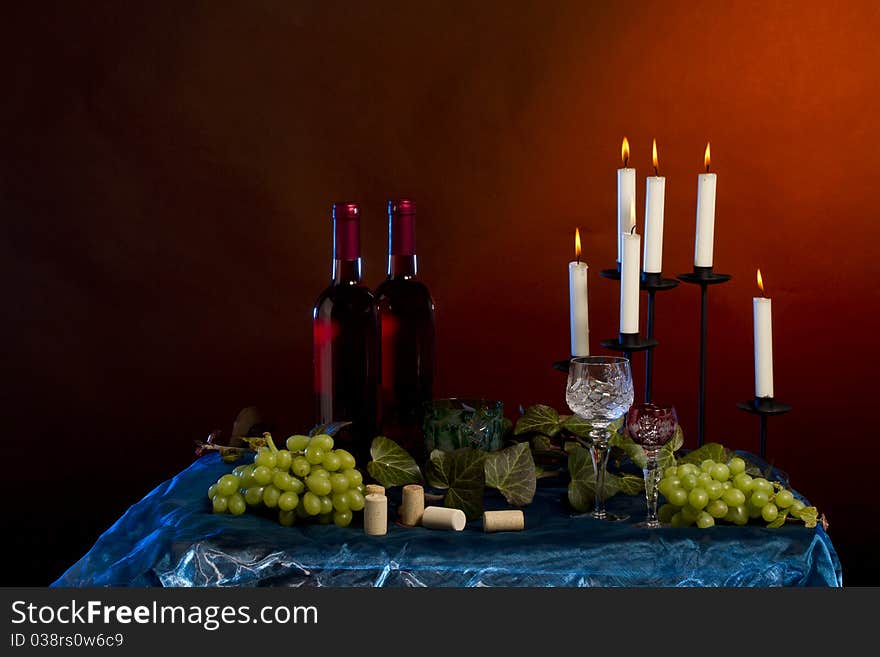 Arrangement of wine bottle, glass, grapes, vine plant, corks in studio. Arrangement of wine bottle, glass, grapes, vine plant, corks in studio