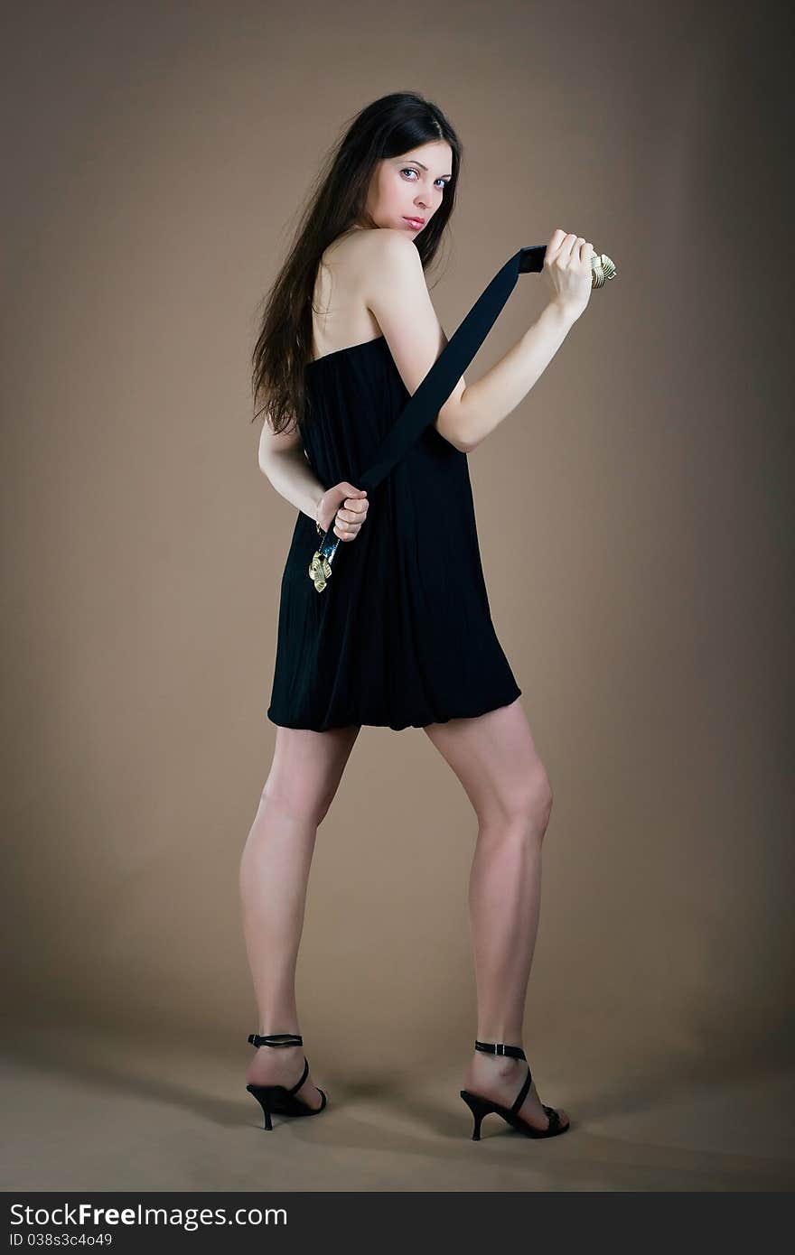 Young woman posing with a girdle posing in studio. Young woman posing with a girdle posing in studio