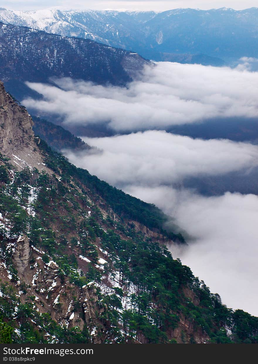 Mountain valley with declivity and white cloud. Composition of the nature