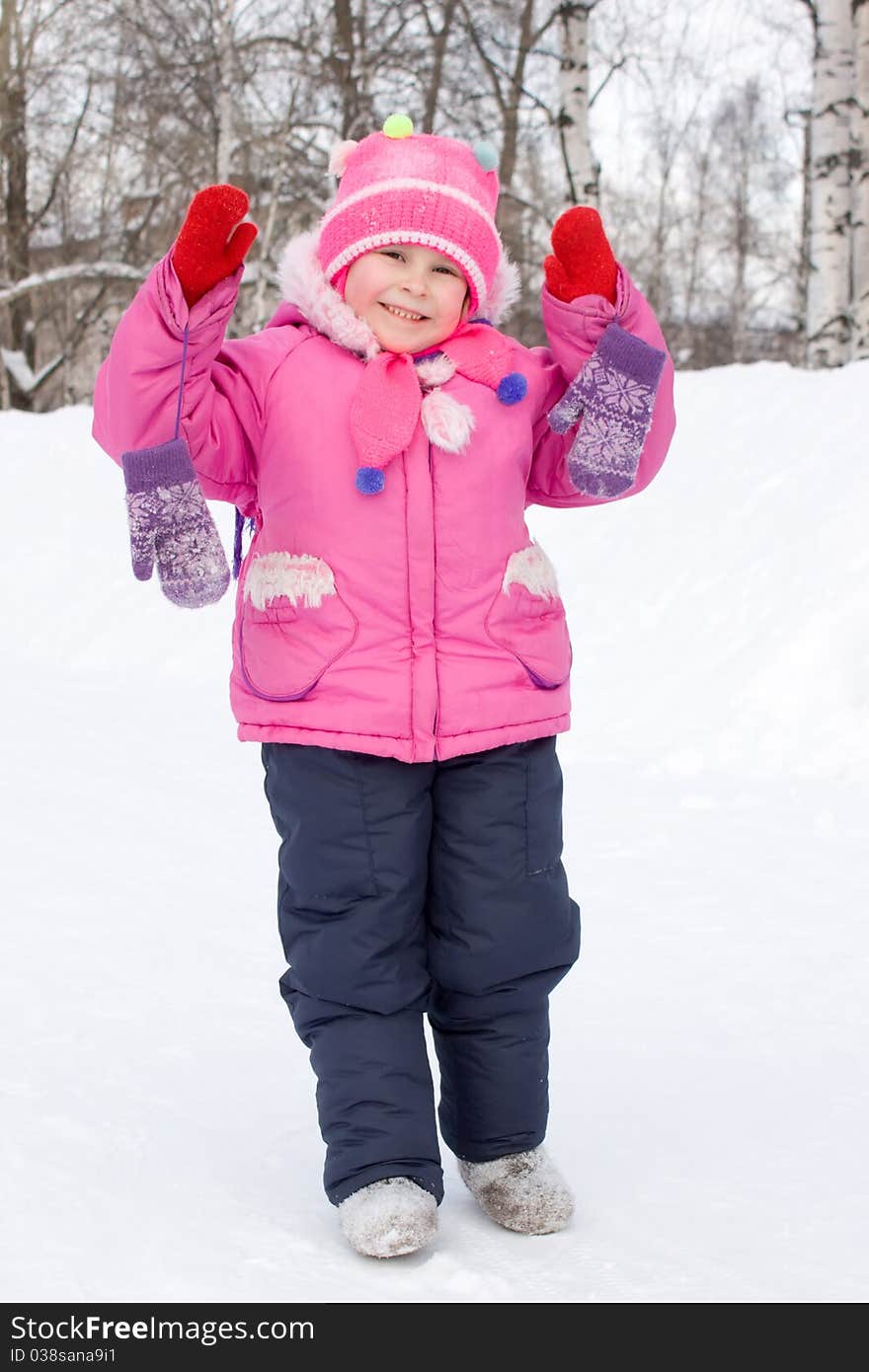 Girl smiling in winter mittens.