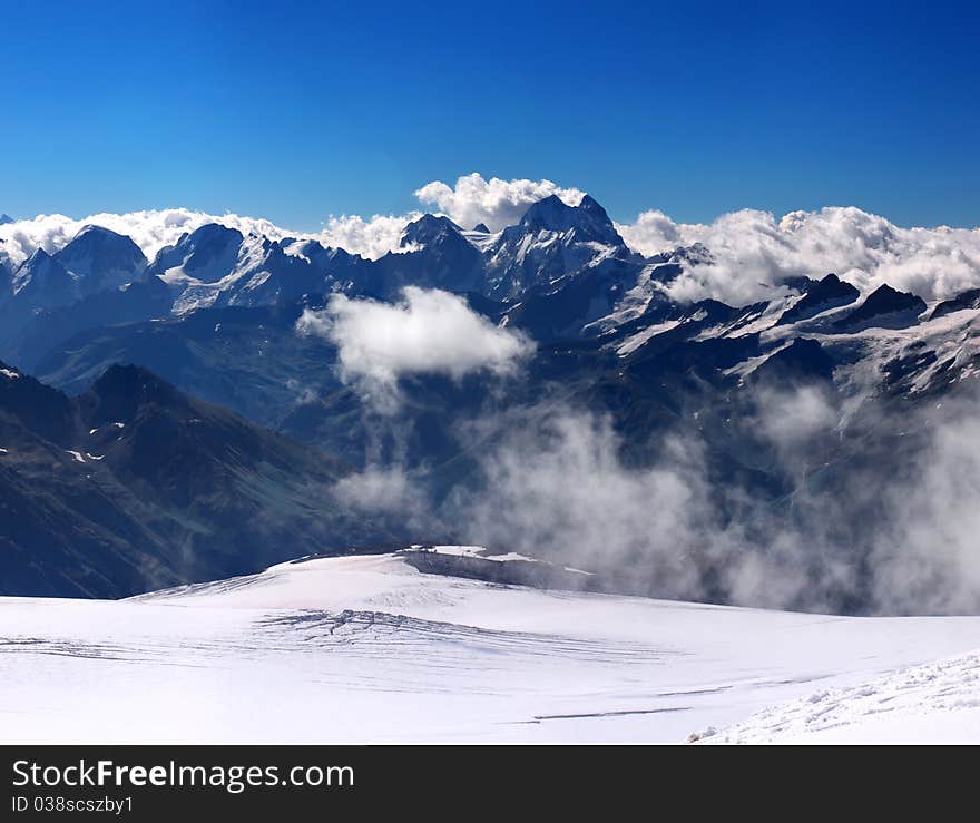 Dark mountains on background blue sky in winter. Natural composition