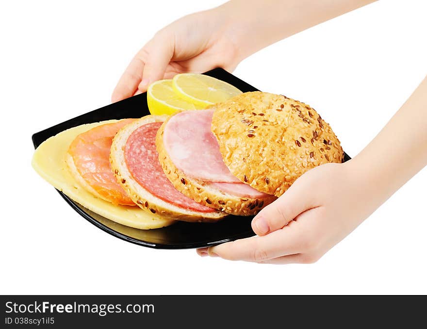 Sandwich on a plate in hands. Isolated on white.