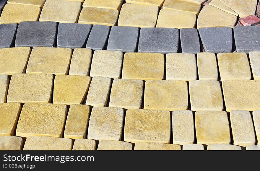 Terrace of yellow and red stone paved in rows