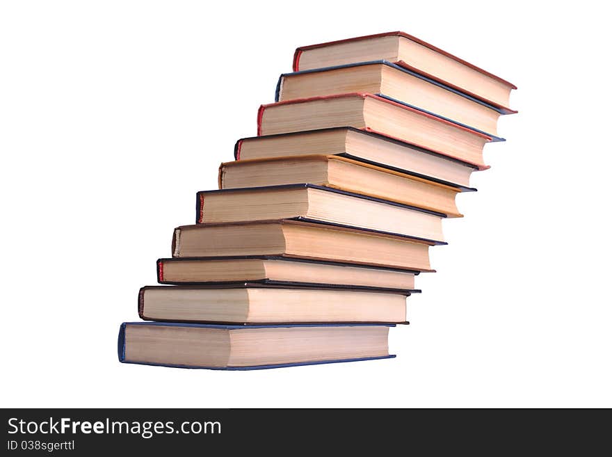 Various old books lying obliquely on the white table