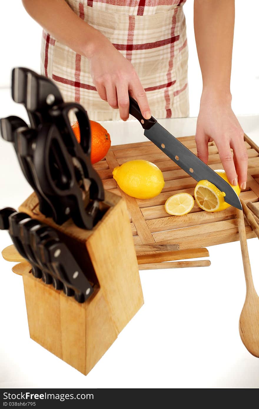 Girl Cutting Lemon In Slices