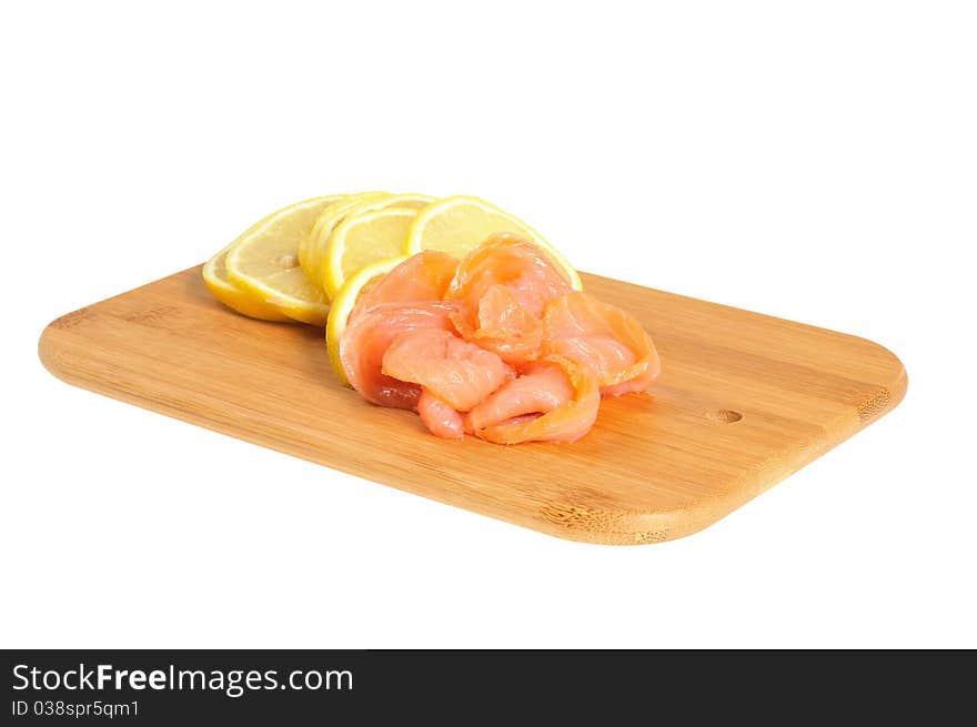 Salmon and lemon on wooden board. Isolated on white. Salmon and lemon on wooden board. Isolated on white