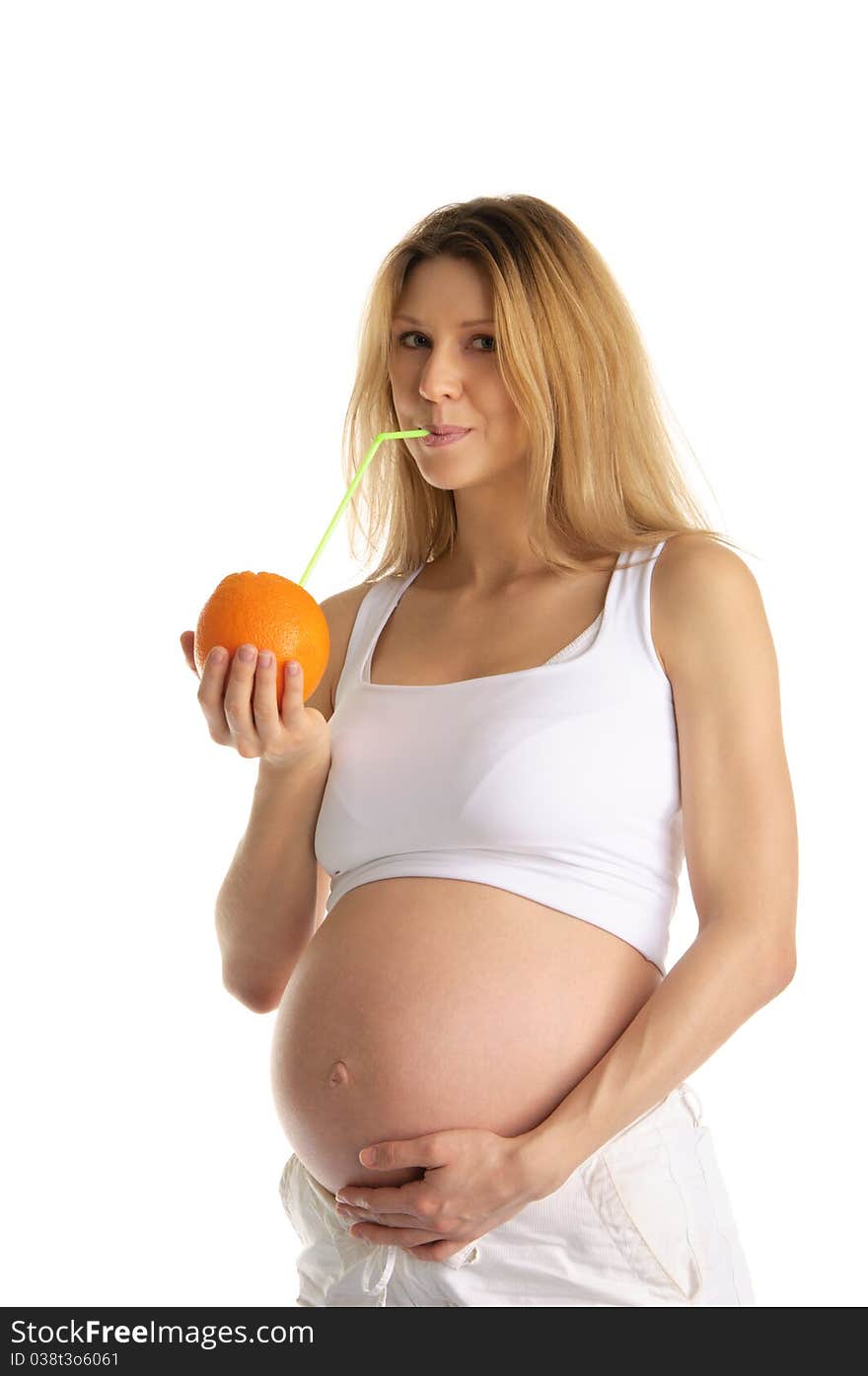 Pregnant woman drinking juice from the orange isolated on white