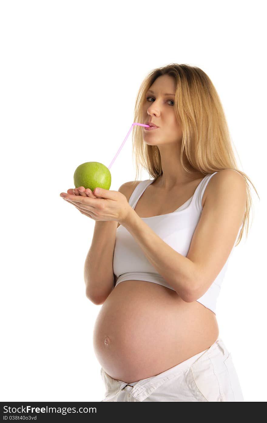 Pregnant woman drinking juice from apple