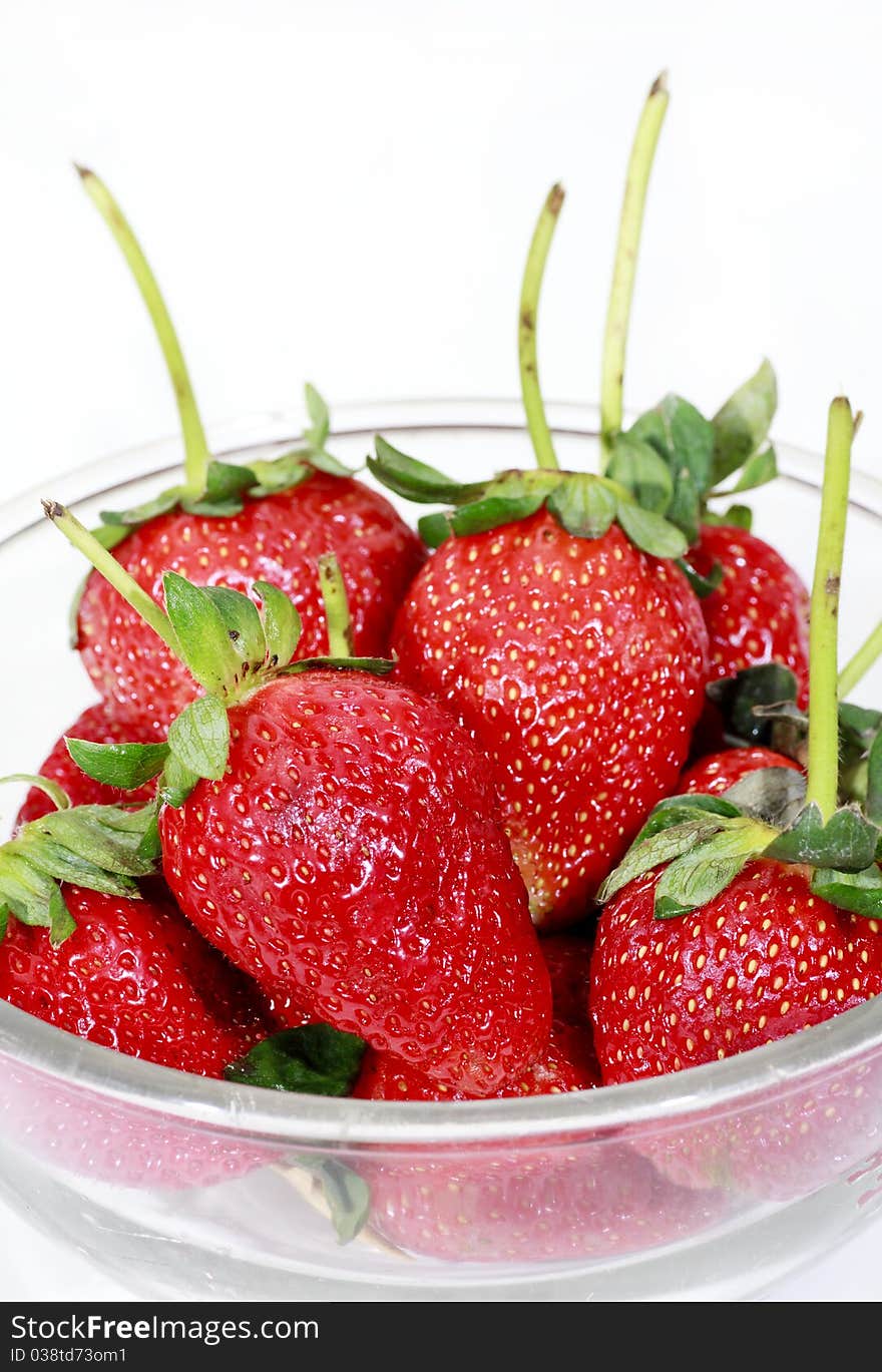 Red strawberry in a bowl isolated on white