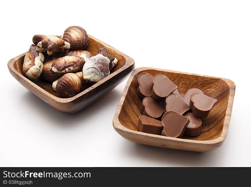 Chocolates with heart in the wood bowl