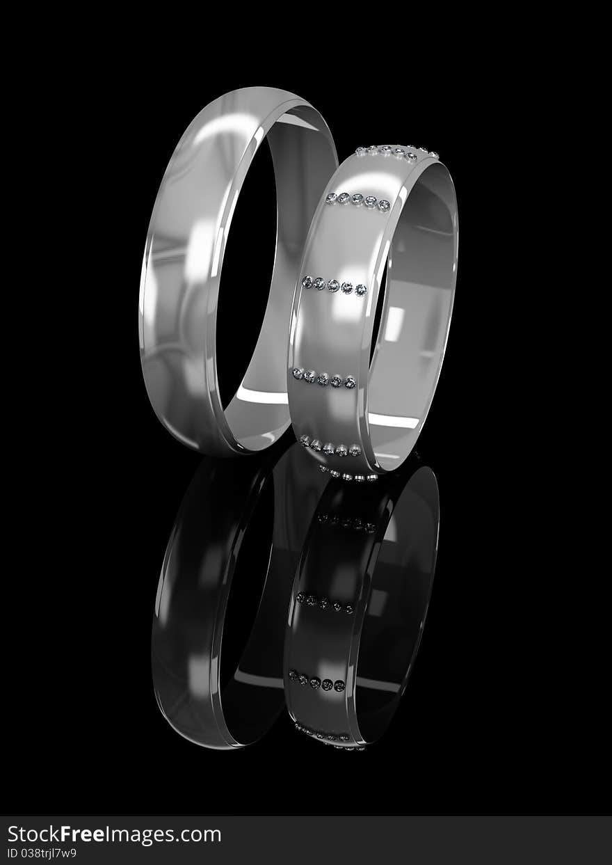 Wedding rings with brilliants on a black background