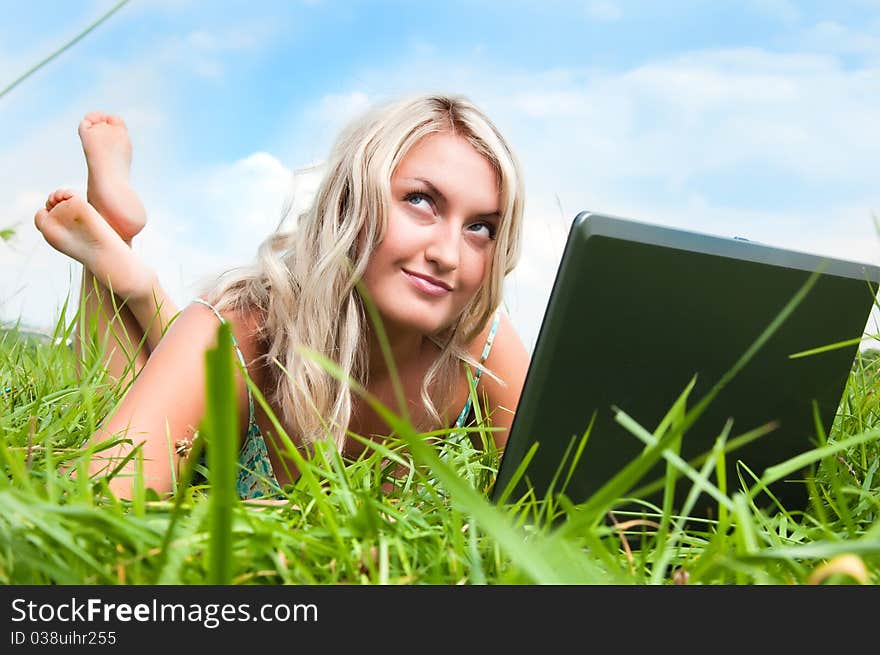 Beautiful girl on the meadow with notebook. Beautiful girl on the meadow with notebook