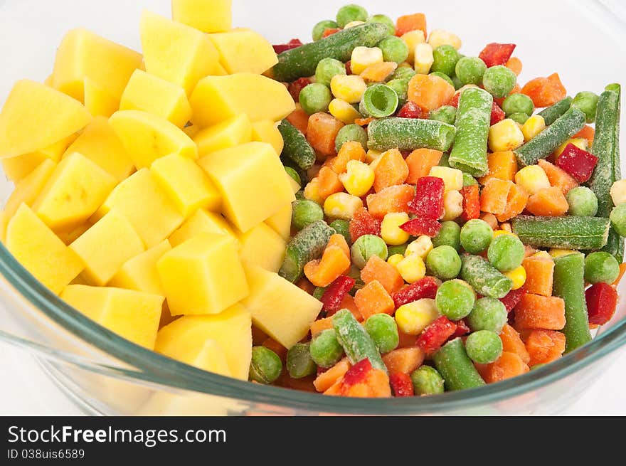 Closeup with potatoes and frozen mixed vegetables