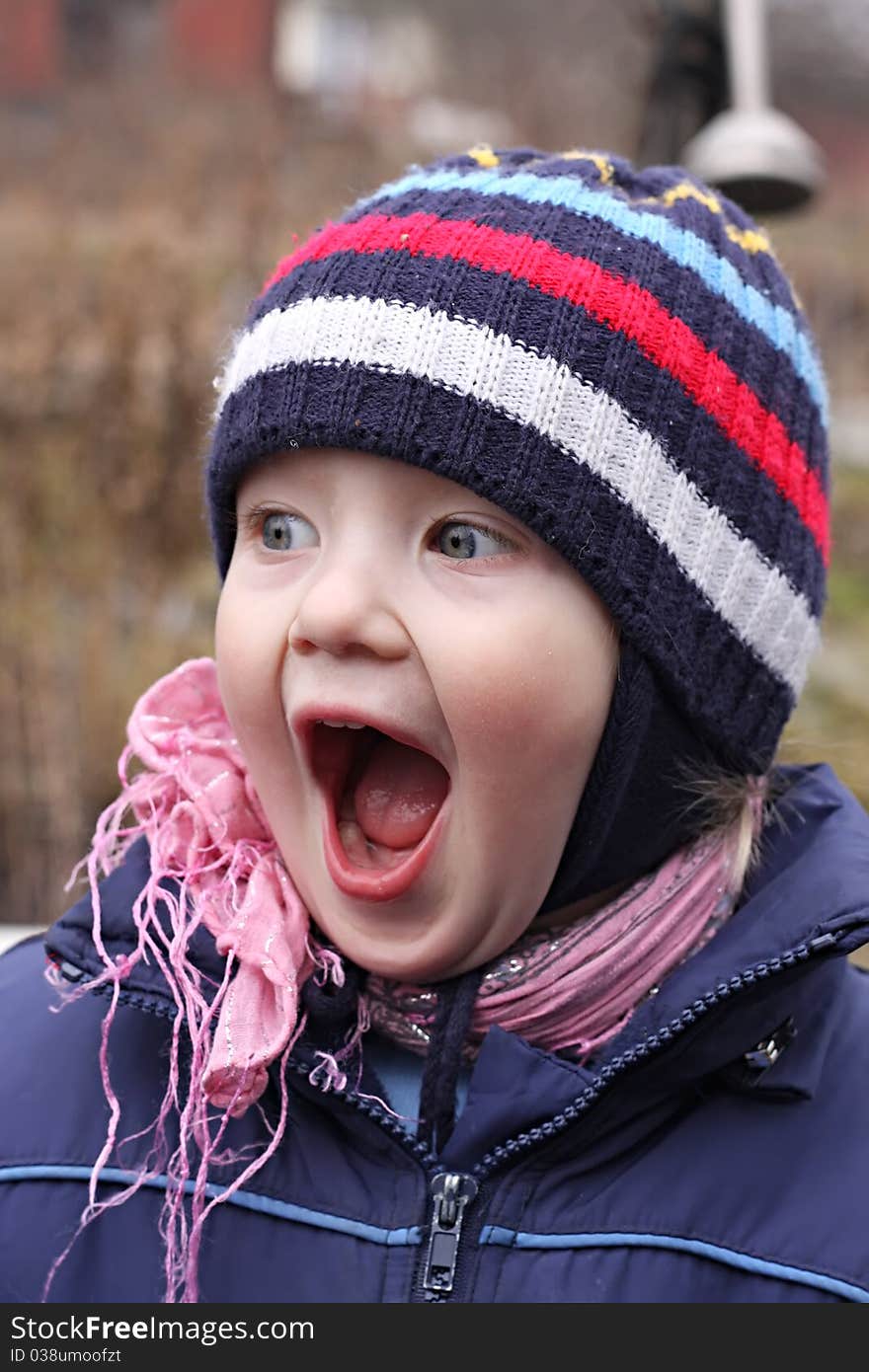 Portrait of the little boy, with widely open mouth which shouts.