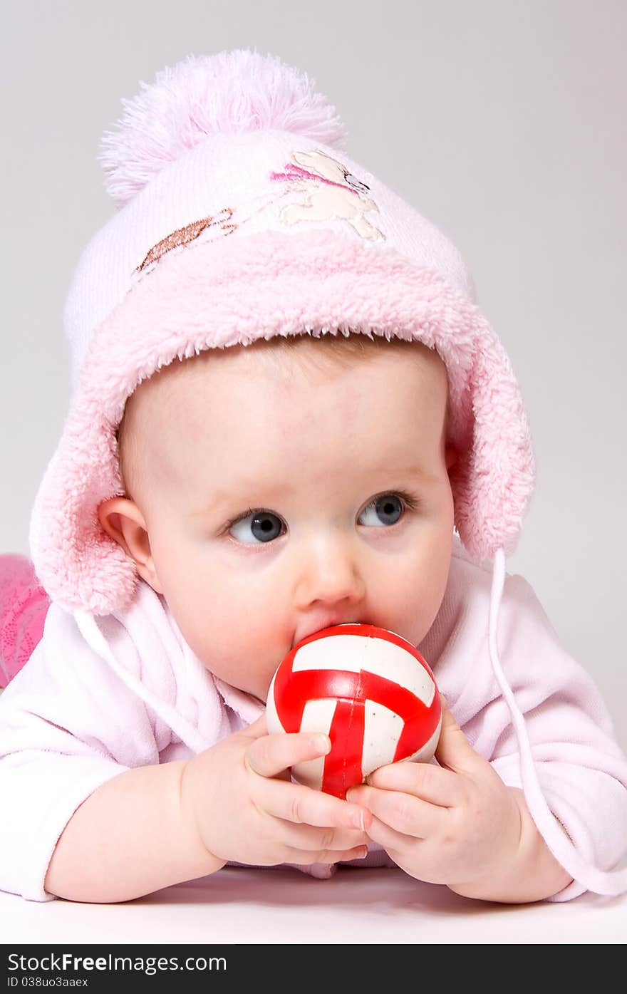 Little child baby with red ball