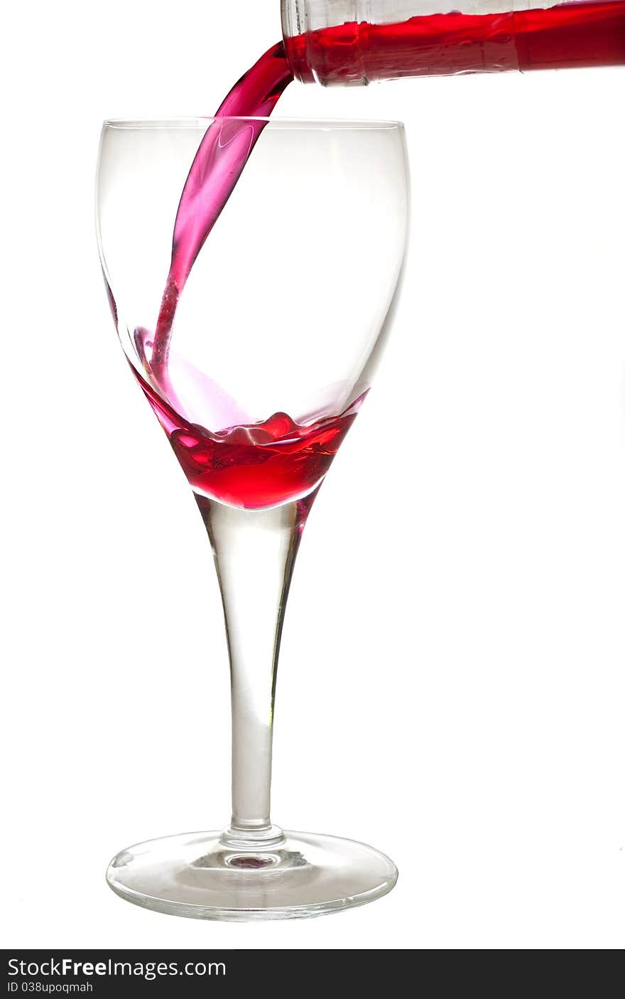 Filling a crystal glass with cherry liquer, drink, on white background. Filling a crystal glass with cherry liquer, drink, on white background