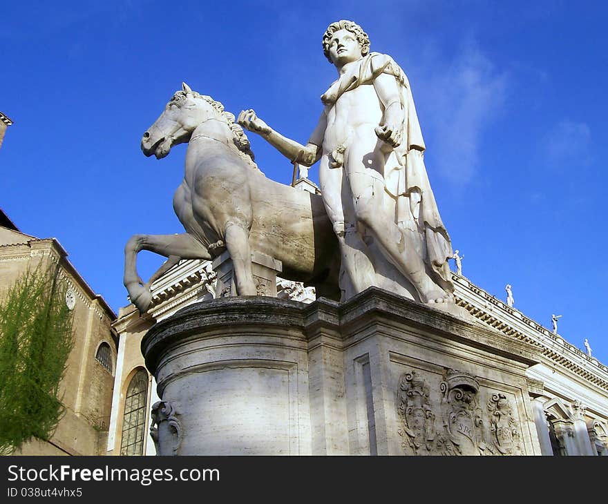 The capitol in rome showing one of the ancient statues flanking the stairway