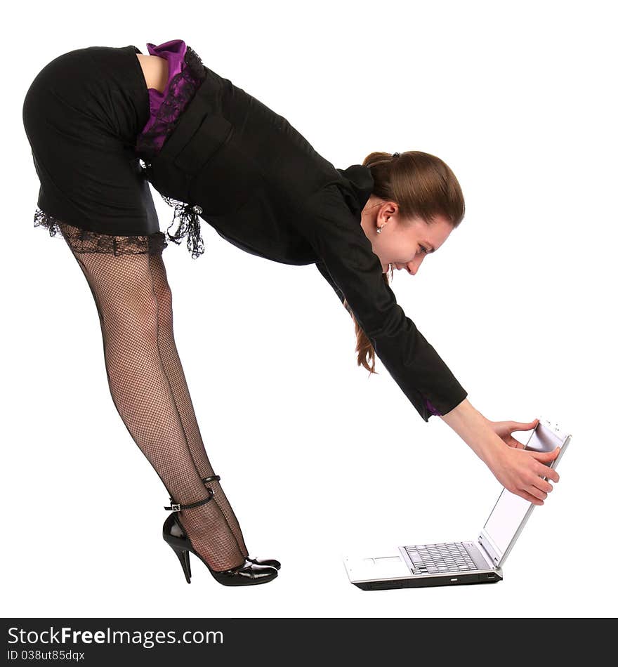 Girl in black suit opens notebook on floor.