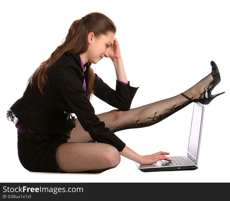 Girl in black suit sits on floor and put leg on notebook. Isolated on white. Girl in black suit sits on floor and put leg on notebook. Isolated on white.