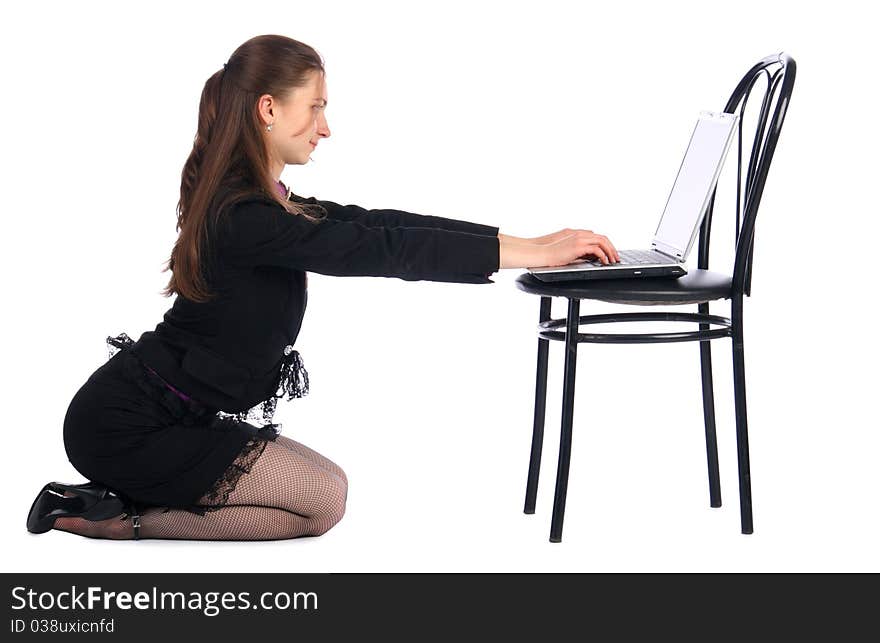 Girl sits on floor and works with notebook on stoo