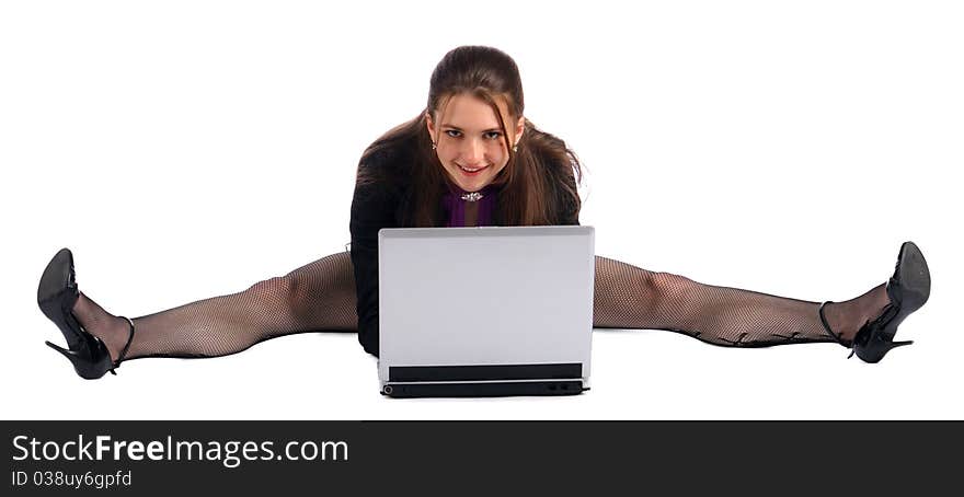 Girl makes splits with notebook on floor. Isolated on white.