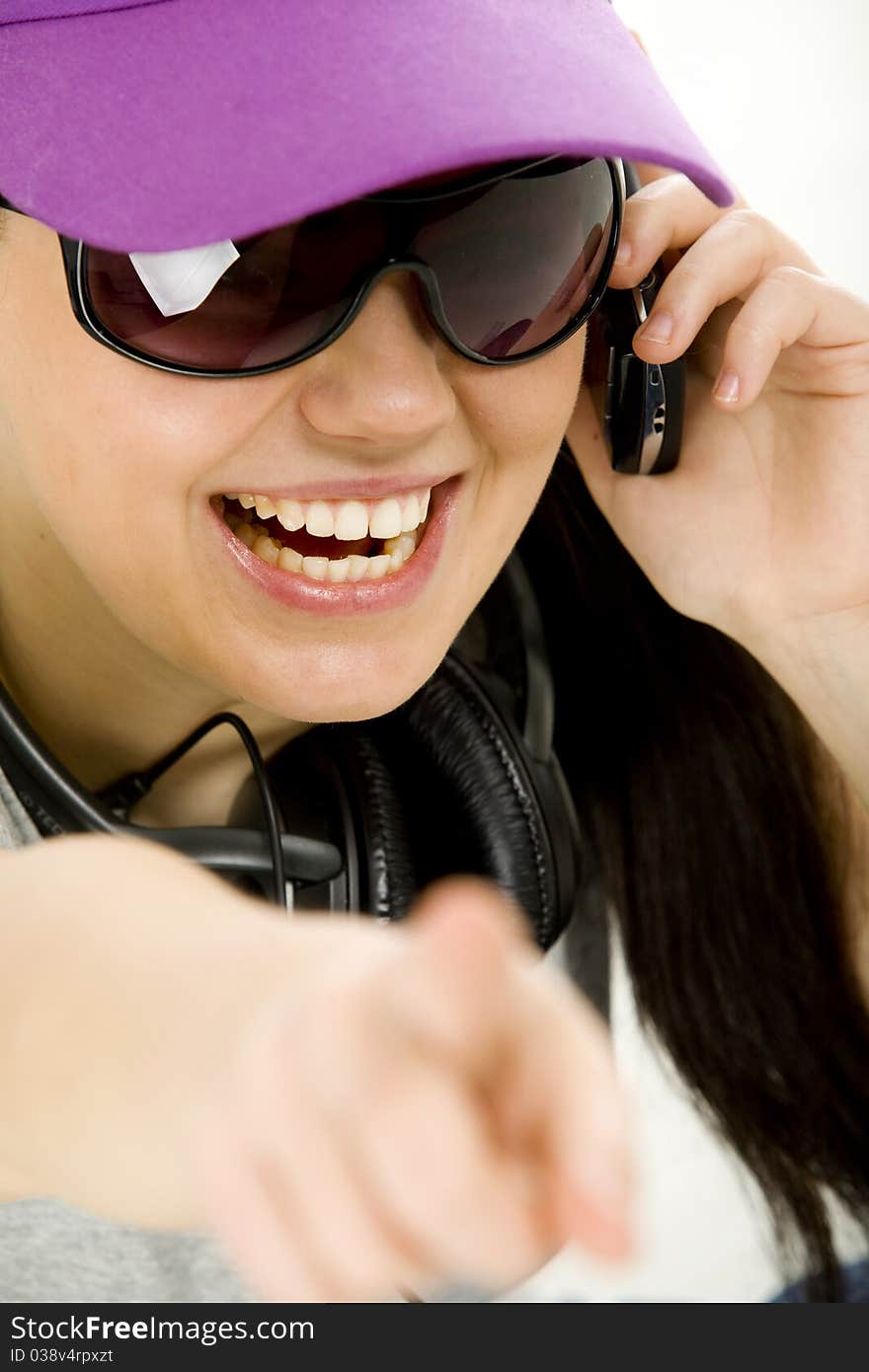 Young woman on the phone with headset, pointing at something. Young woman on the phone with headset, pointing at something