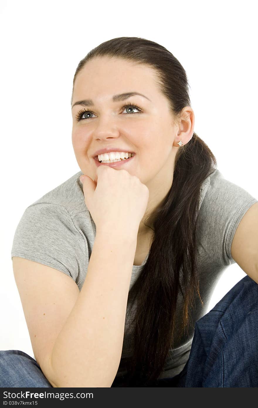 Pretty young woman sitting on the floor , smiling