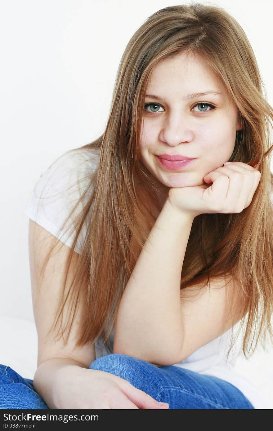 Beautiful young woman with a funny expression on her face looking at the camera isolated on white background. Beautiful young woman with a funny expression on her face looking at the camera isolated on white background