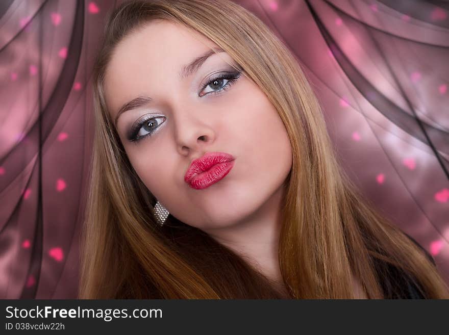 Kiss of a beautiful young woman. Valentine.