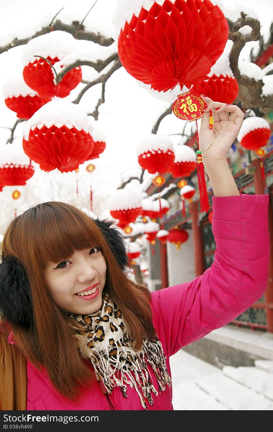 After New Year's first snow,it symbolizes good luck. Beautiful Chinese girl enjoying red lantern and Chinese knot in Chinese new year.(Close-up) Chinese characters on Chinese knot are Good Fortune and Get rich. After New Year's first snow,it symbolizes good luck. Beautiful Chinese girl enjoying red lantern and Chinese knot in Chinese new year.(Close-up) Chinese characters on Chinese knot are Good Fortune and Get rich