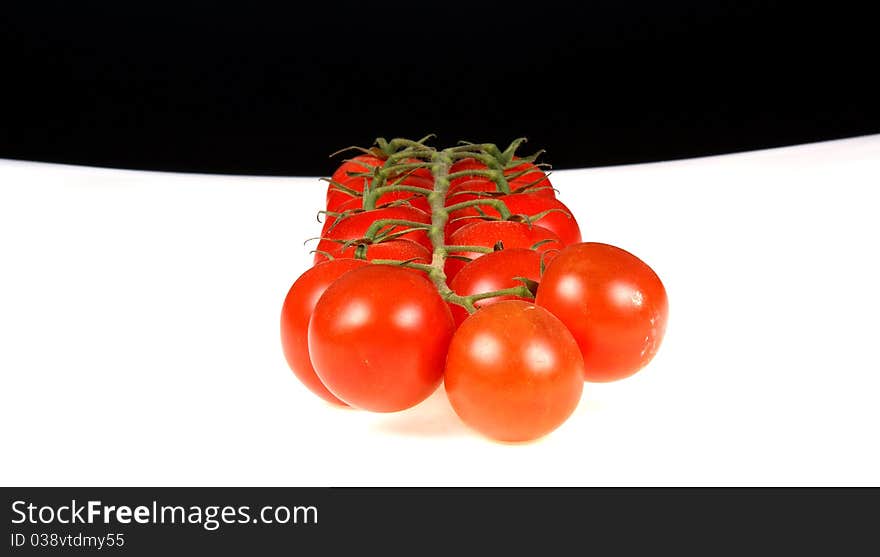 Cherry tomato --is a smaller garden variety of tomato, on a white and black background